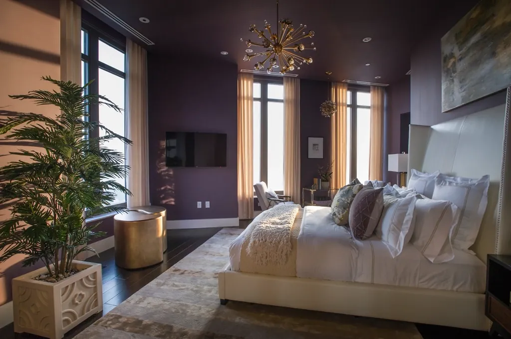 Moody bedroom with floor-length drapery on tall windows