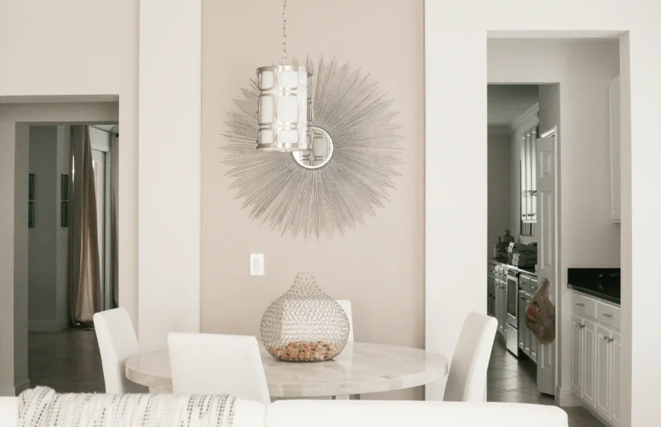 Light breakfast nook with sunburst mirror
