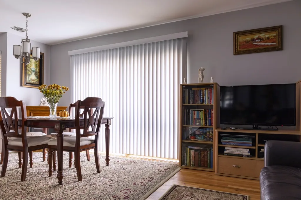 Vertical blinds across a sliding door in a dining room